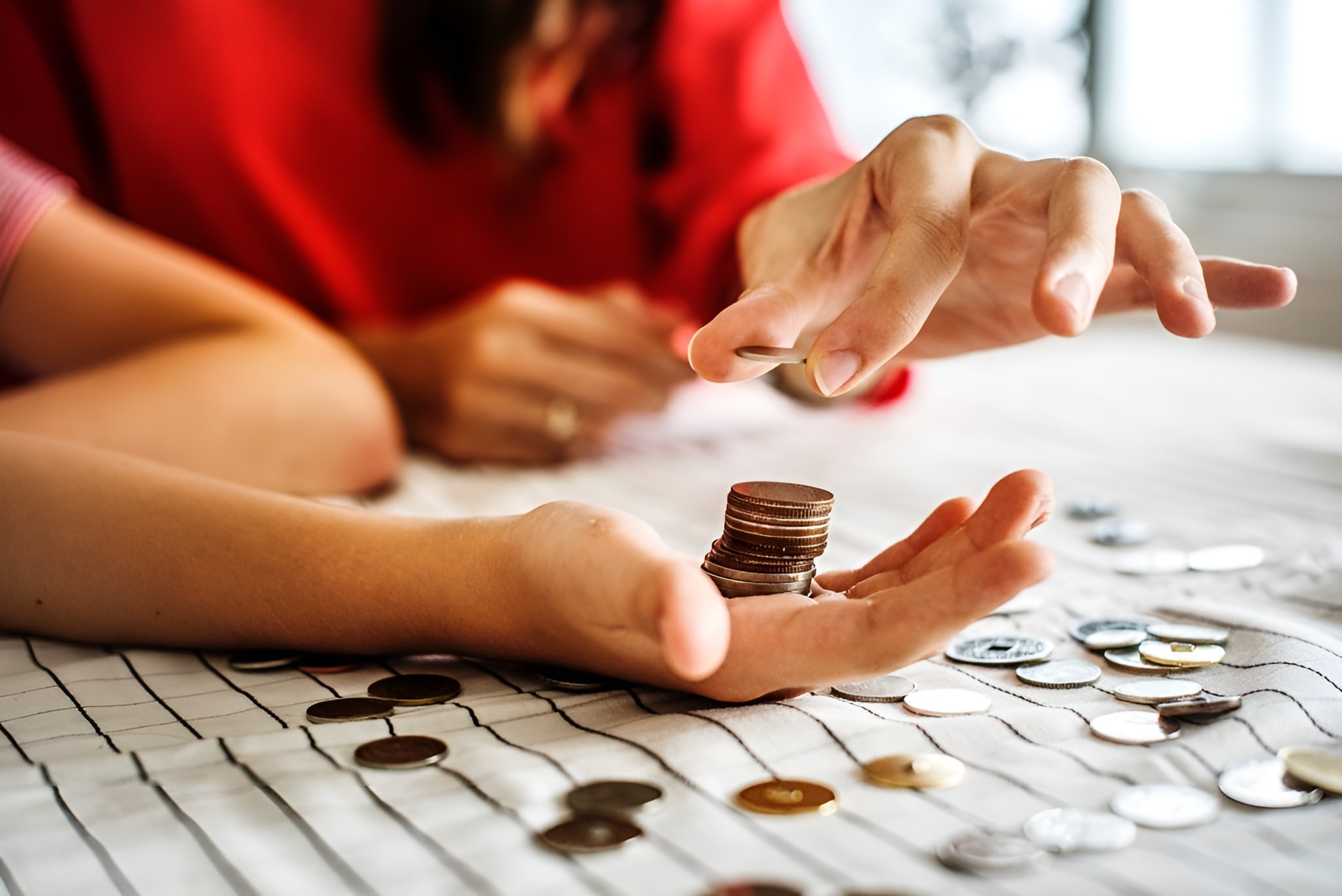 Hands stacking coins, representing NOVADECI emergency loan support