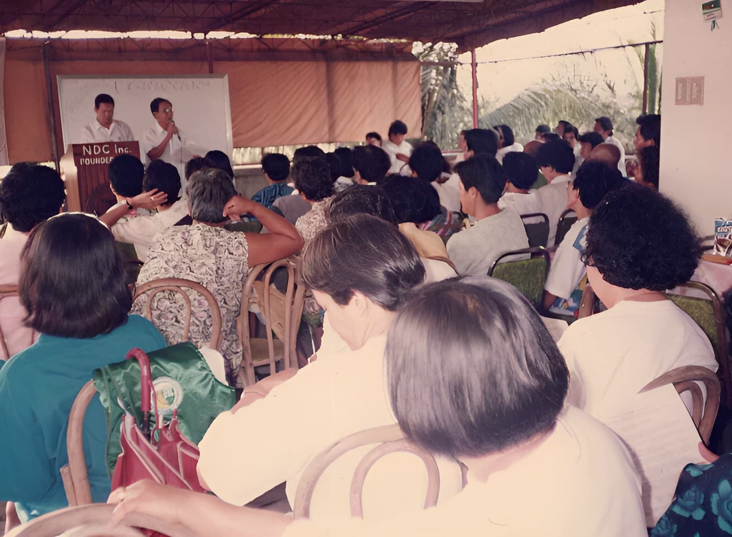Early NOVADECI founders meeting with members in a covered hall