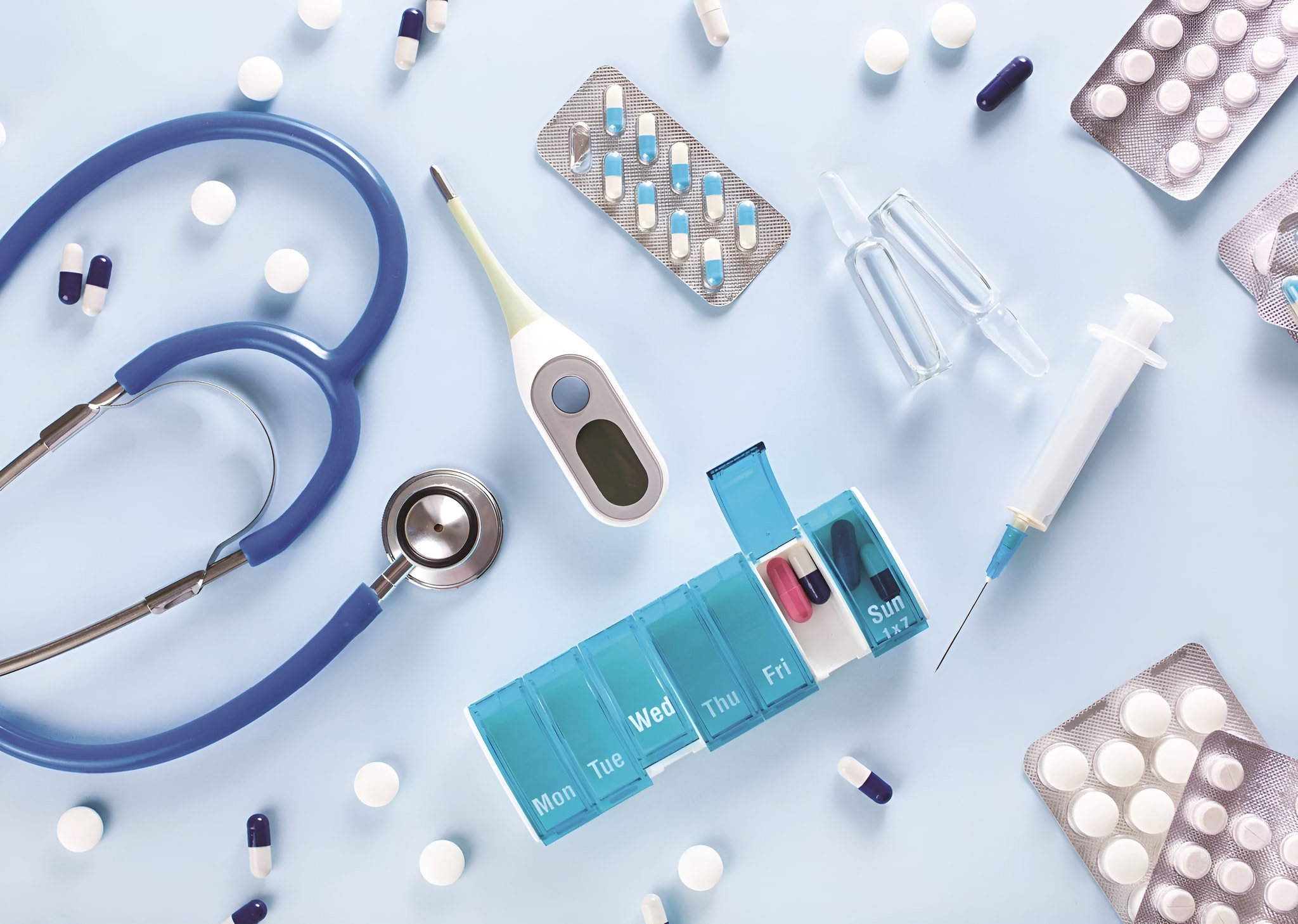 Medical supplies including a stethoscope, thermometer, and medications