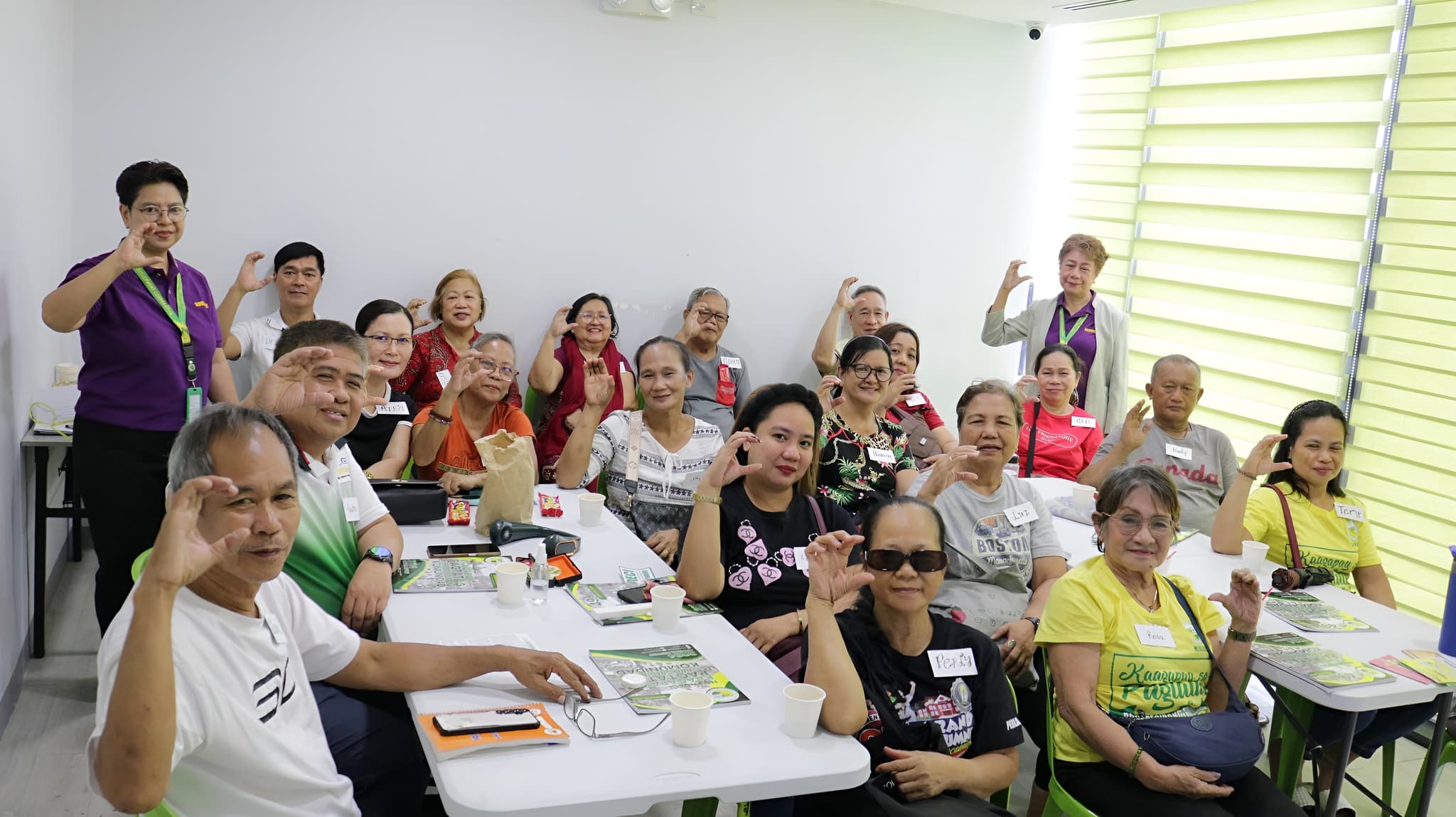 NOVADECI members gathered together making the cooperative hand gesture