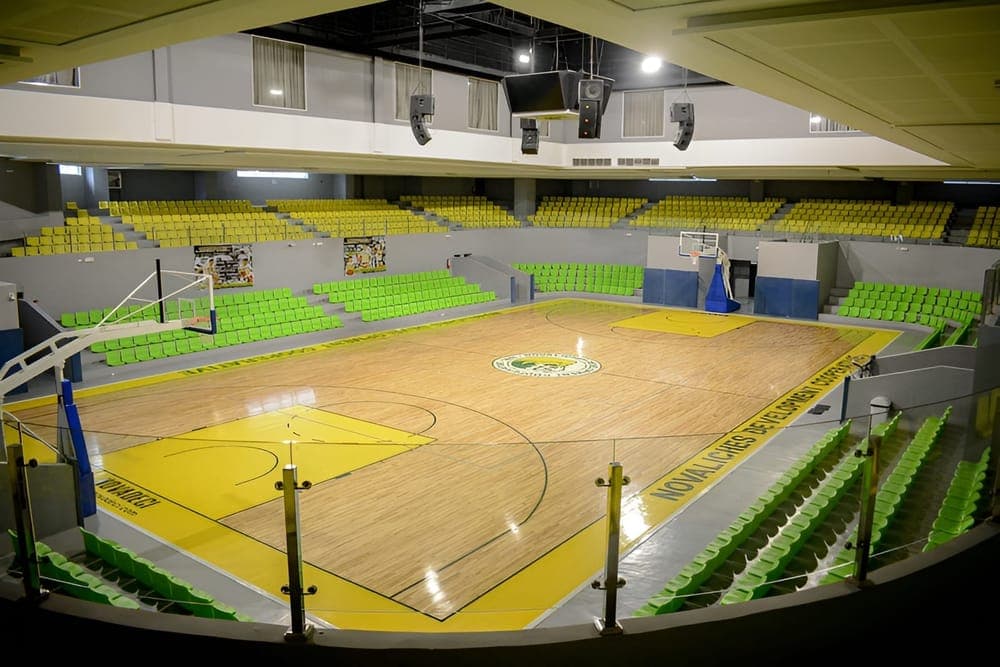 Indoor sports facility with basketball court and stadium seating