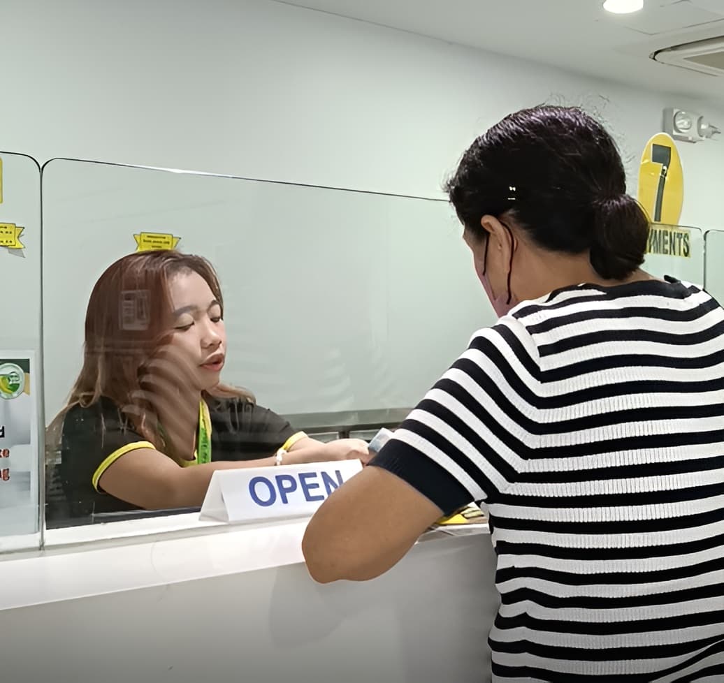 NOVADECI teller assisting a member at the service counter